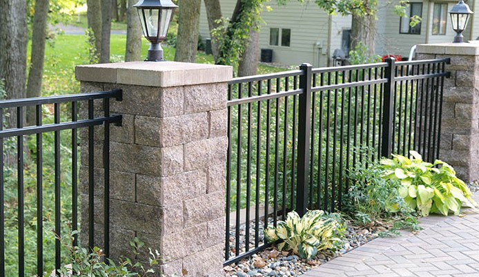 block pillar and metal rail fence